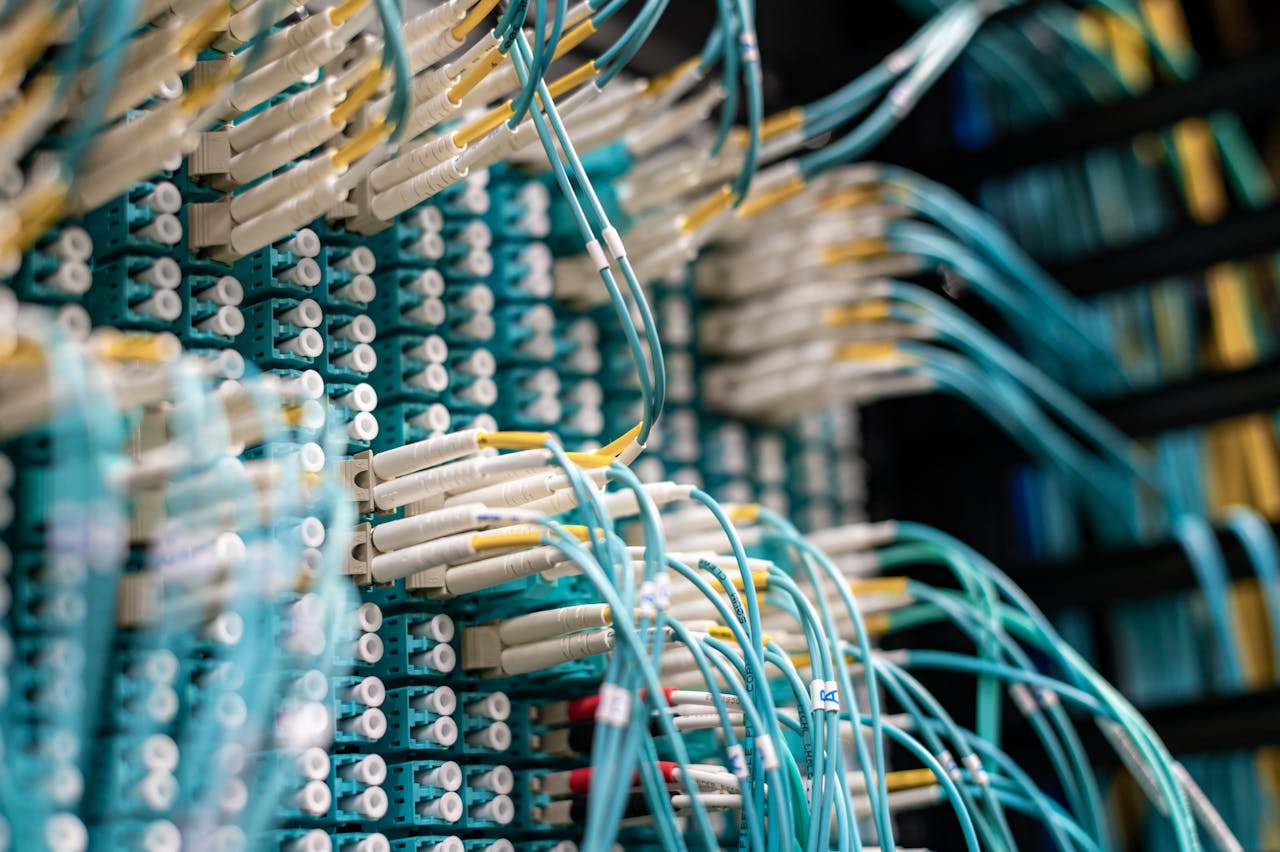 Detailed view of fiber optic cables connected to a patch panel in a data center.